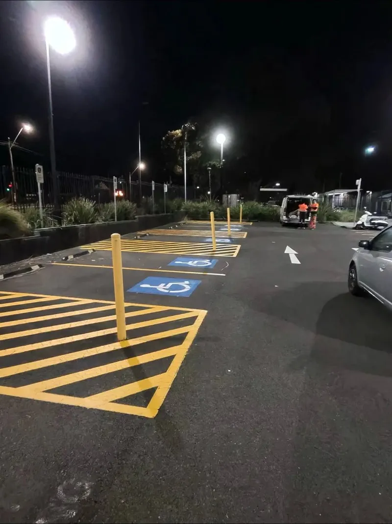 Speedy Line Marking crew completing accessible bay line marking after hours under car park lighting