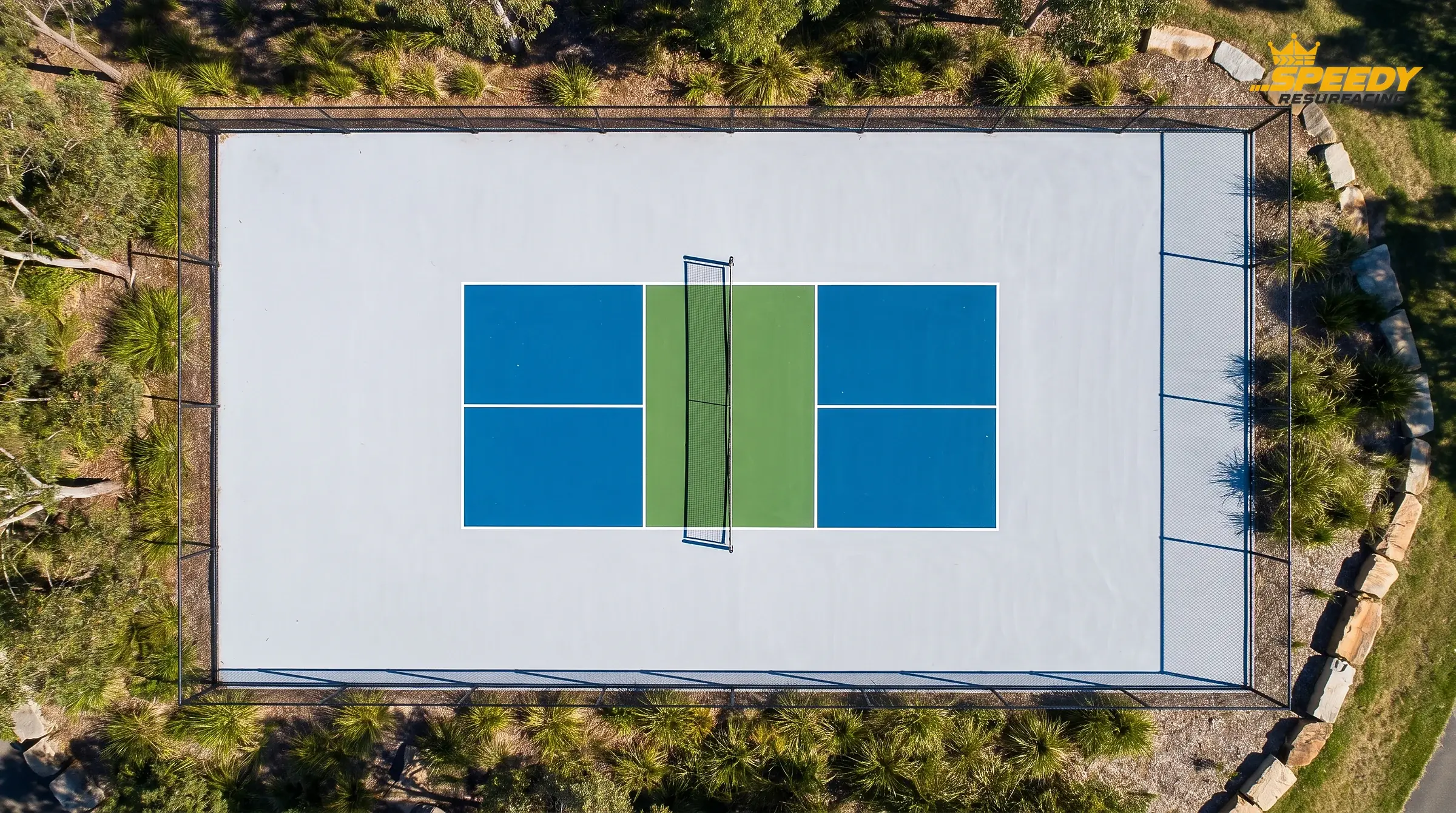The marked 20 × 44 ft playing rectangle sits inside a 30 × 60 ft (9.14 × 18.29 m) envelope — the plain apron is run-off space that keeps players clear of fences, poles and structures.