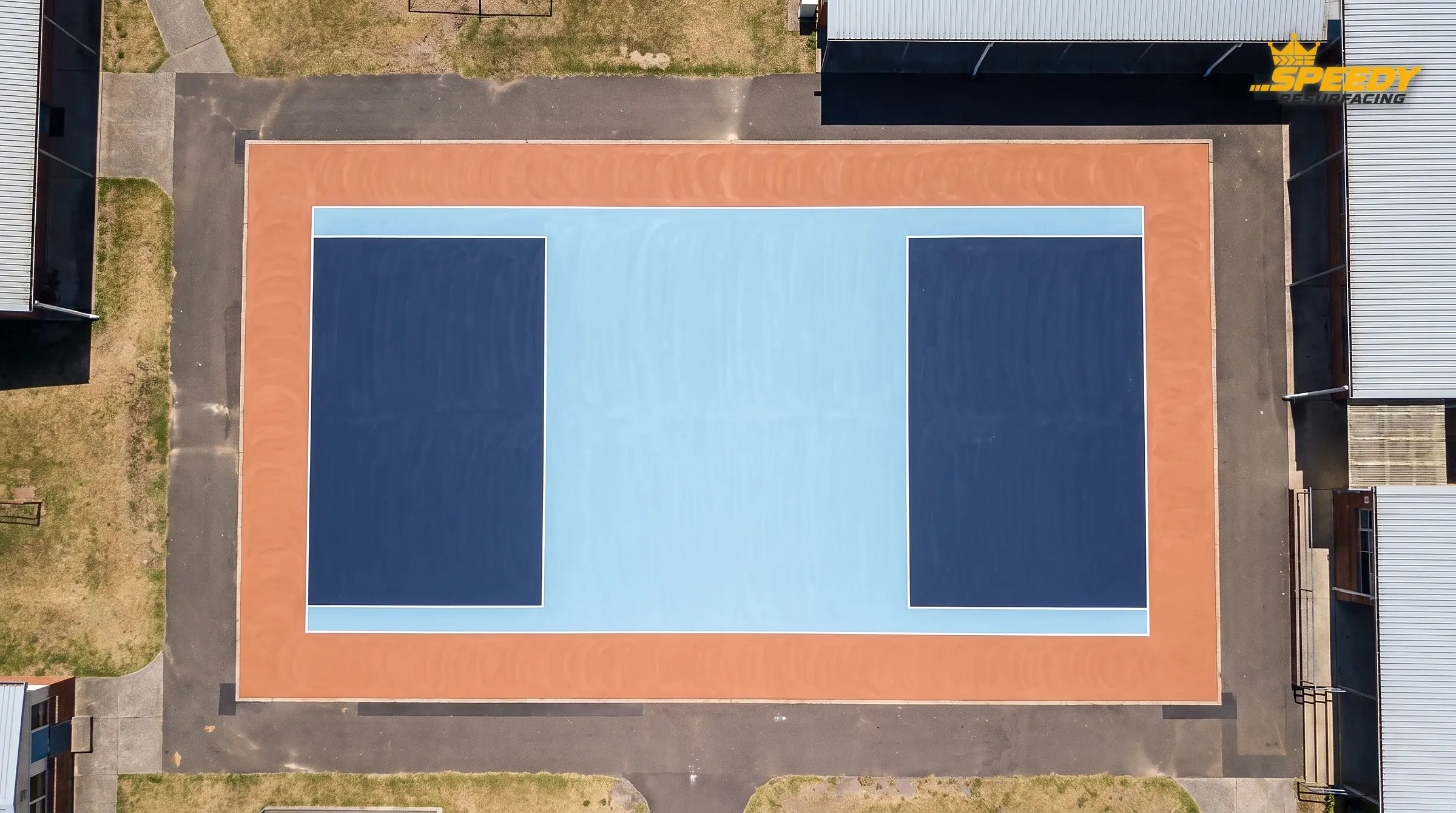 Colour fills first: navy keyways, a light-blue playing zone and a terracotta apron define the layout before a single line is painted.