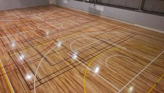 Centre circle and multi-sport lines on a restored timber school sports hall floor