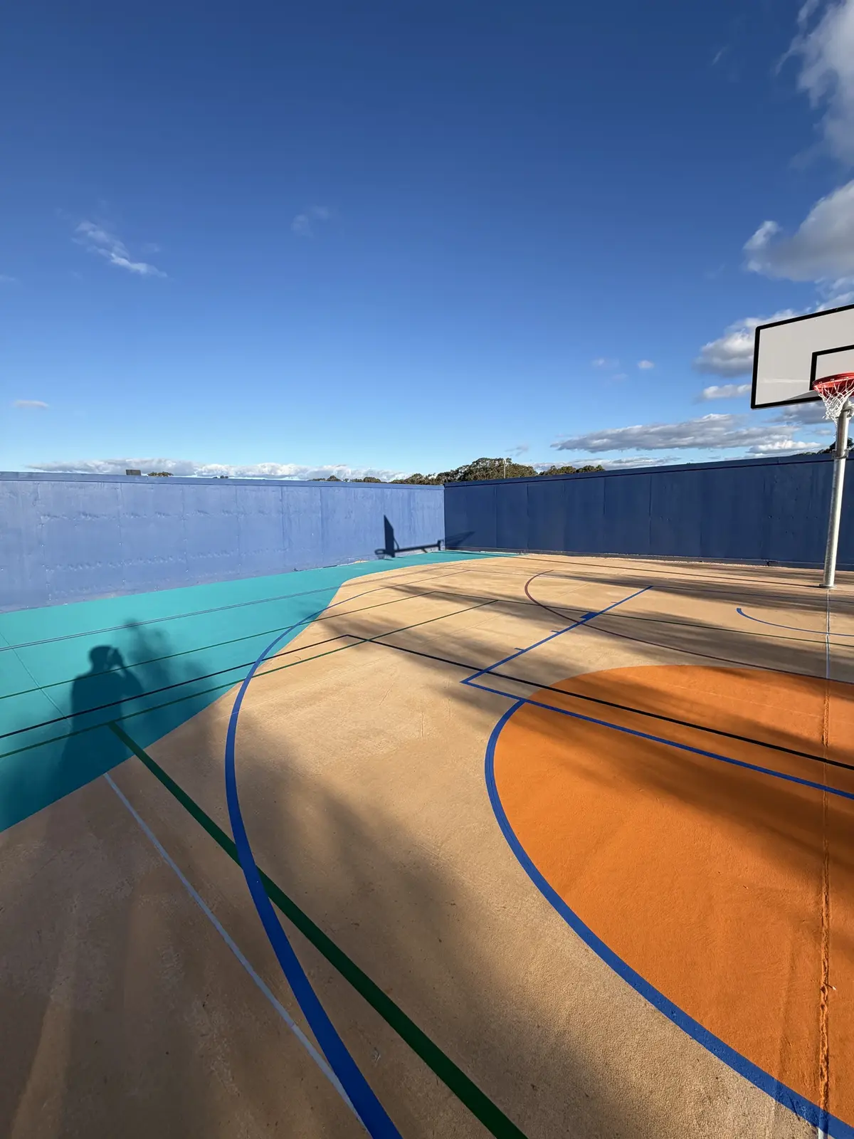 Court resurfacing by Team Speedy — fresh surface at golden hour